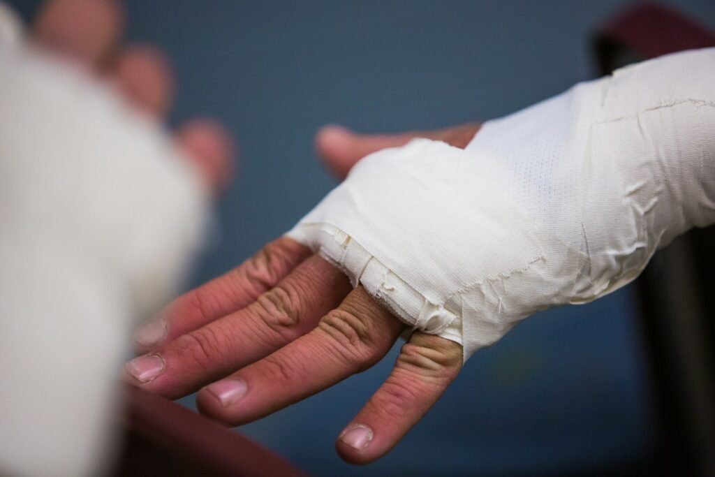 Person with a white bandage on their hand