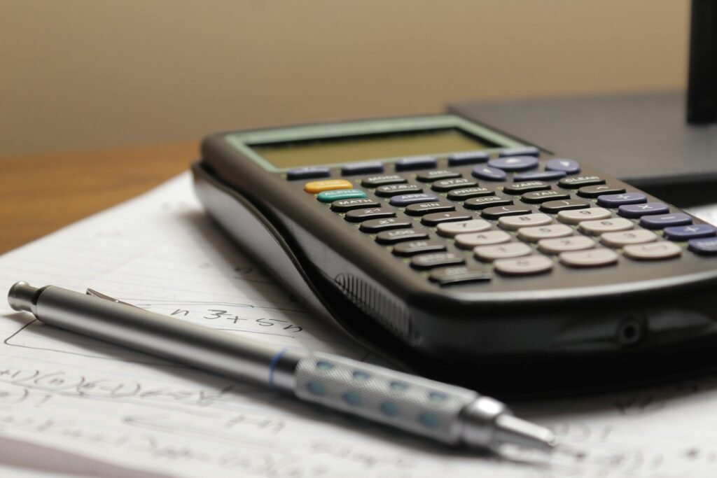 Calculator and pen on top of paperwork