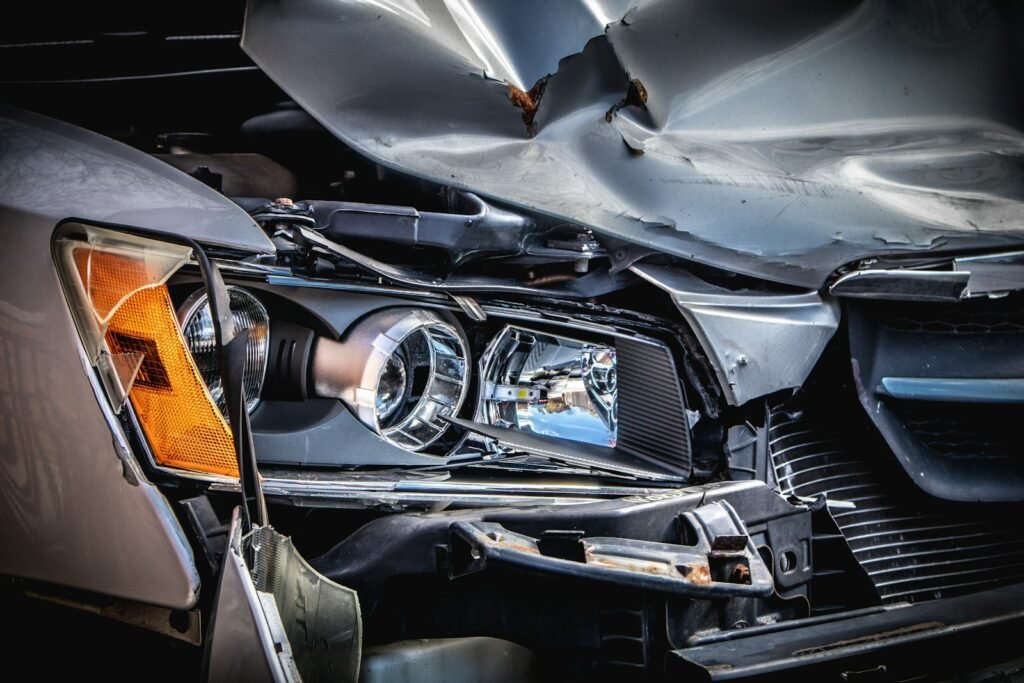 Damaged silver car with a crushed hood after a crash