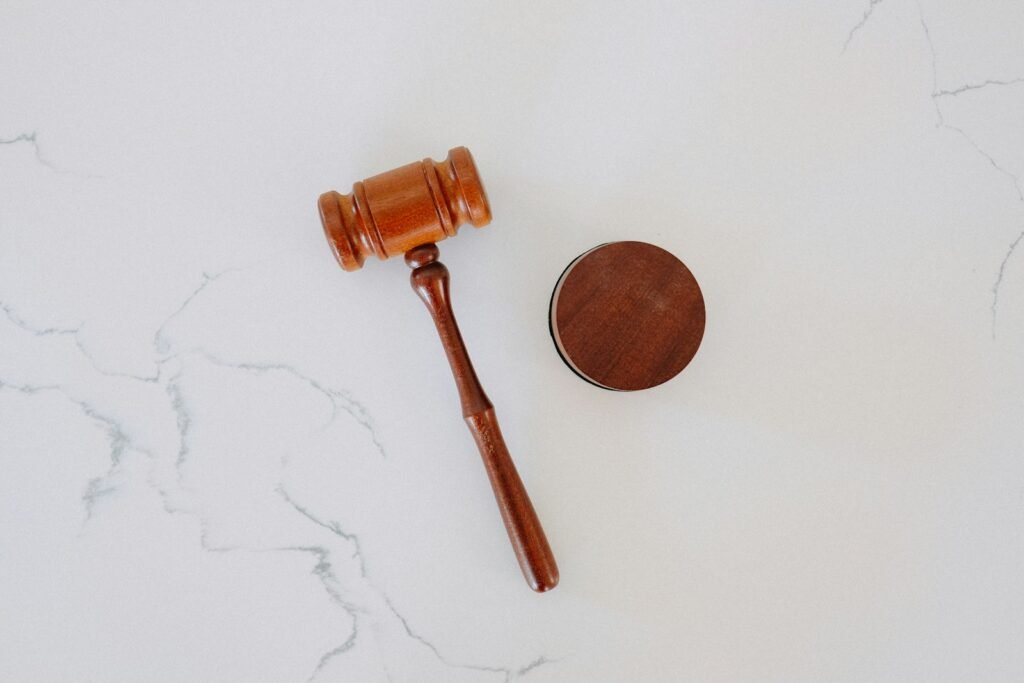 Wooden judge's gavel and block on marble